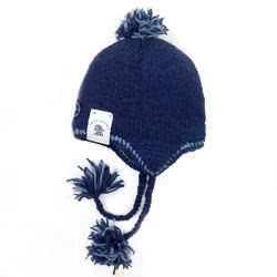 Pachamama Surf Chullo Hat Denim. These hand knitted Pachamama chullo hats are made from 100% wool with a 
fleece lining. They come with ear flaps and navy braids finished with fluffy bobbles. Knitted in Nepal by local villagers using local wools and natu