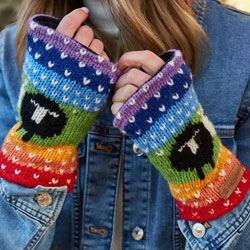 Pachamama Black Sheep Handwarmer Rainbow. These Pachamama Handwarmers are knitted in Nepal by local villagers using local wools and natural dyes to UK designs..These fingerless gloves feature a delightful sheep pattern over the top of a vibrant knitted ra