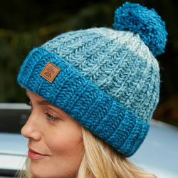 Pachamama Cotopaxi Bobble Beanie Teal Hat. These Pachamama Bobble Beanies are knitted in Nepal by local villagers using local wools and natural dyes to UK designs. Featuring a deep teal rim and bobble, with paler teal bands in a ribbed pattern for a good 