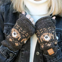 Pachamama Pooch Dog Handwarmer Bark. These Pachamama fingerless gloves are knitted in Nepal by local villagers using local wools and natural dyes to UK designs. Each handwarmer features a bark-brown background with a row of knitted pooch heads and come wi