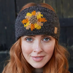 Pachamama Sunflower Headband. These Pachamama Headbands, also known as earwarmers, are knitted in Nepal by local villagers using local wools and natural dyes to UK designs. Featuring an orange, yellow and brown sunflower on a bark-brown background. Every 