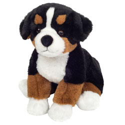 Teddy Hermann Bernese Mountain Dog Sitting 26cm Soft Toy. Coming in a rich tan-brown, black and white coat with a black button nose, long black tail, soft lined ears and dark glossy safety eyes. It is a perfectly proportioned Bernese mountain dog.