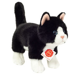 Teddy Hermann Black & White Cat Standing 20cm. Featuring soft fur, glossy blue eyes, upright tail, lined ears.