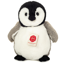 Teddy Hermann Penguin 25cm Plush Toy coming in a mid-grey fur body with a white tummy and face, black webbed feet and head and classic Penguin features.